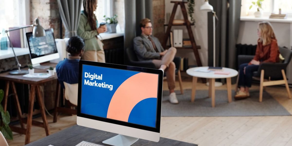 Home Collaborative team meeting in a modern office setting with digital marketing focus.